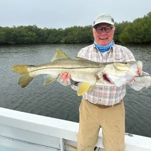 Snook Fishing Charters on Anna Maria Charters man holding a snook