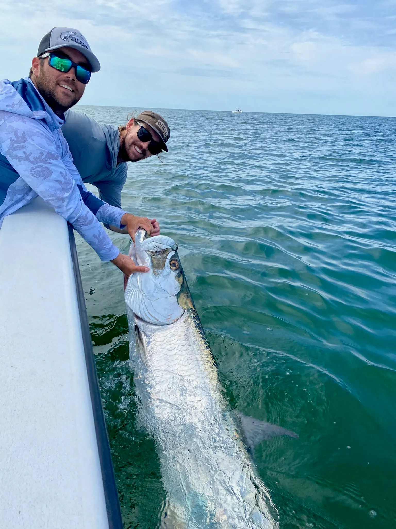 Captain holding a tarpon during a charter near Anna Maria Island